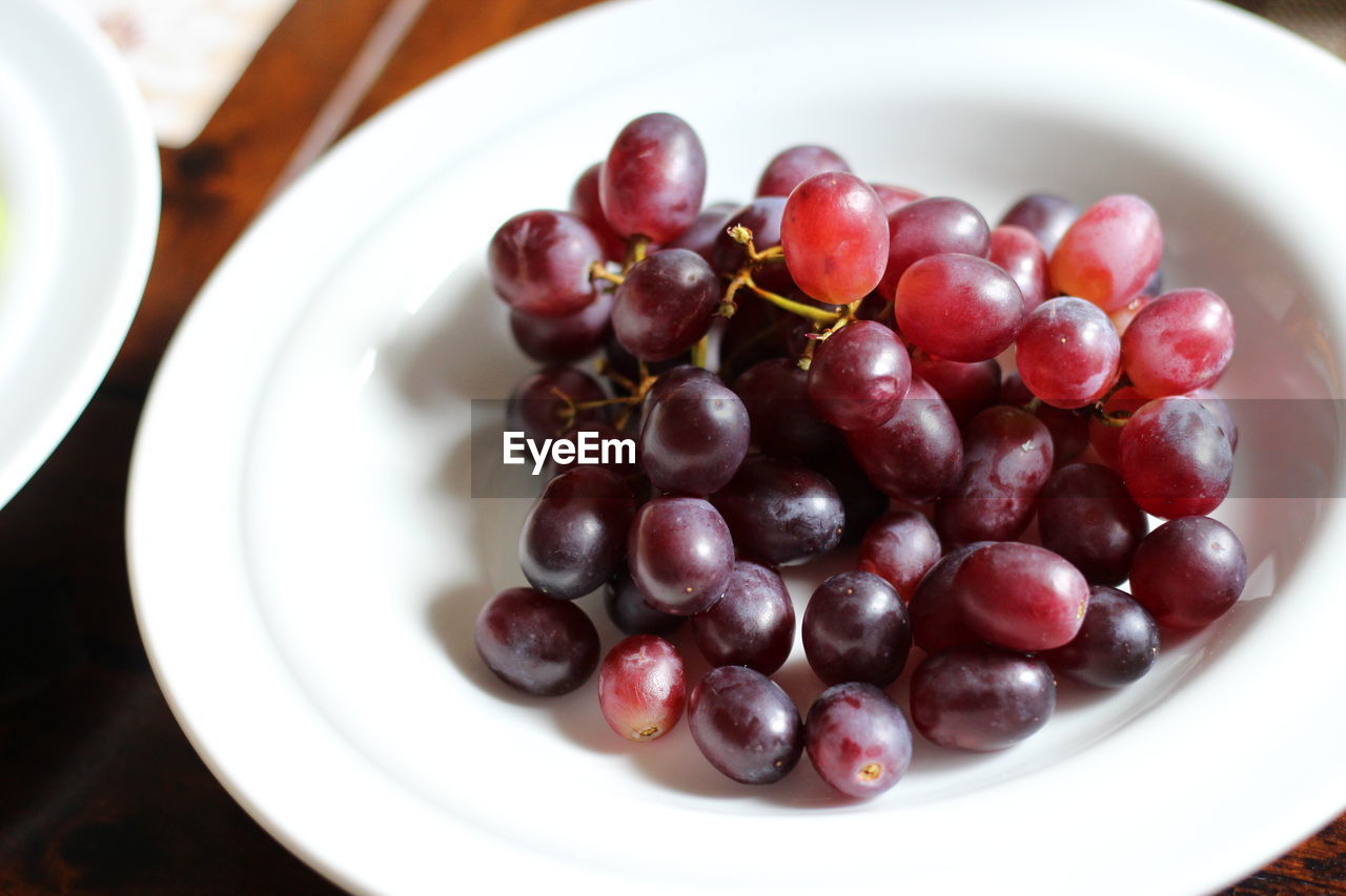 Close-up of red grapes in plate