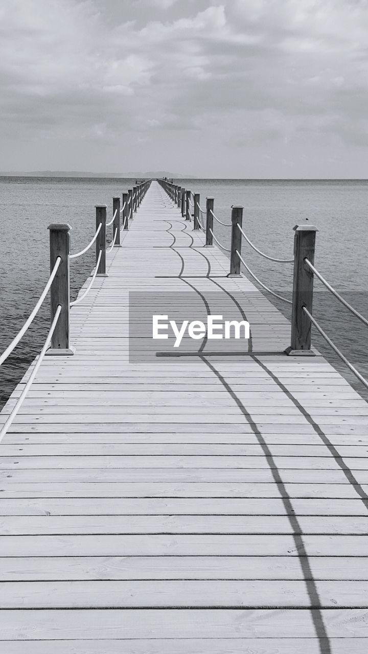 Pier on sea against sky