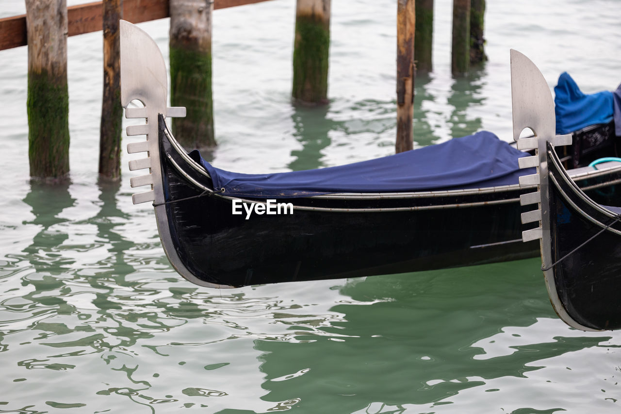 gondola, water, nautical vessel, boat, vehicle, transportation, mode of transportation, canal, boating, travel, nature, travel destinations, watercraft, moored, day, wood, sea, tourism, no people, wooden post, outdoors, tranquility, skiff, long-tail boat, architecture, dinghy, gondolier, reflection, ship's bow, pier, trip, tranquil scene, holiday