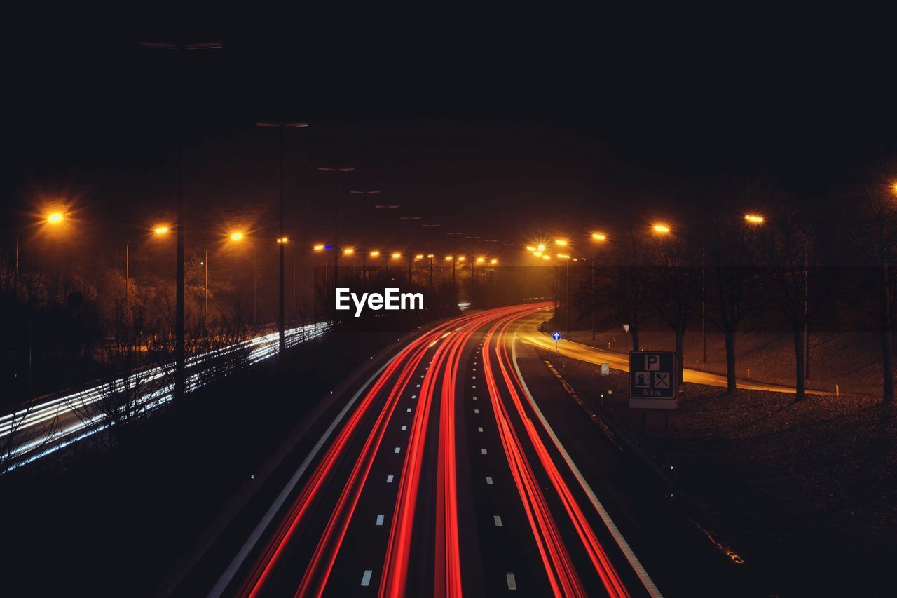 High angle view of light trails on road at night