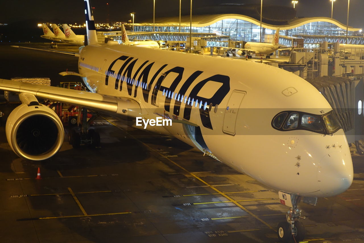 airplane, transportation, mode of transport, yellow, travel, airport, public transportation, air vehicle, no people, night, commercial airplane, illuminated, outdoors, close-up