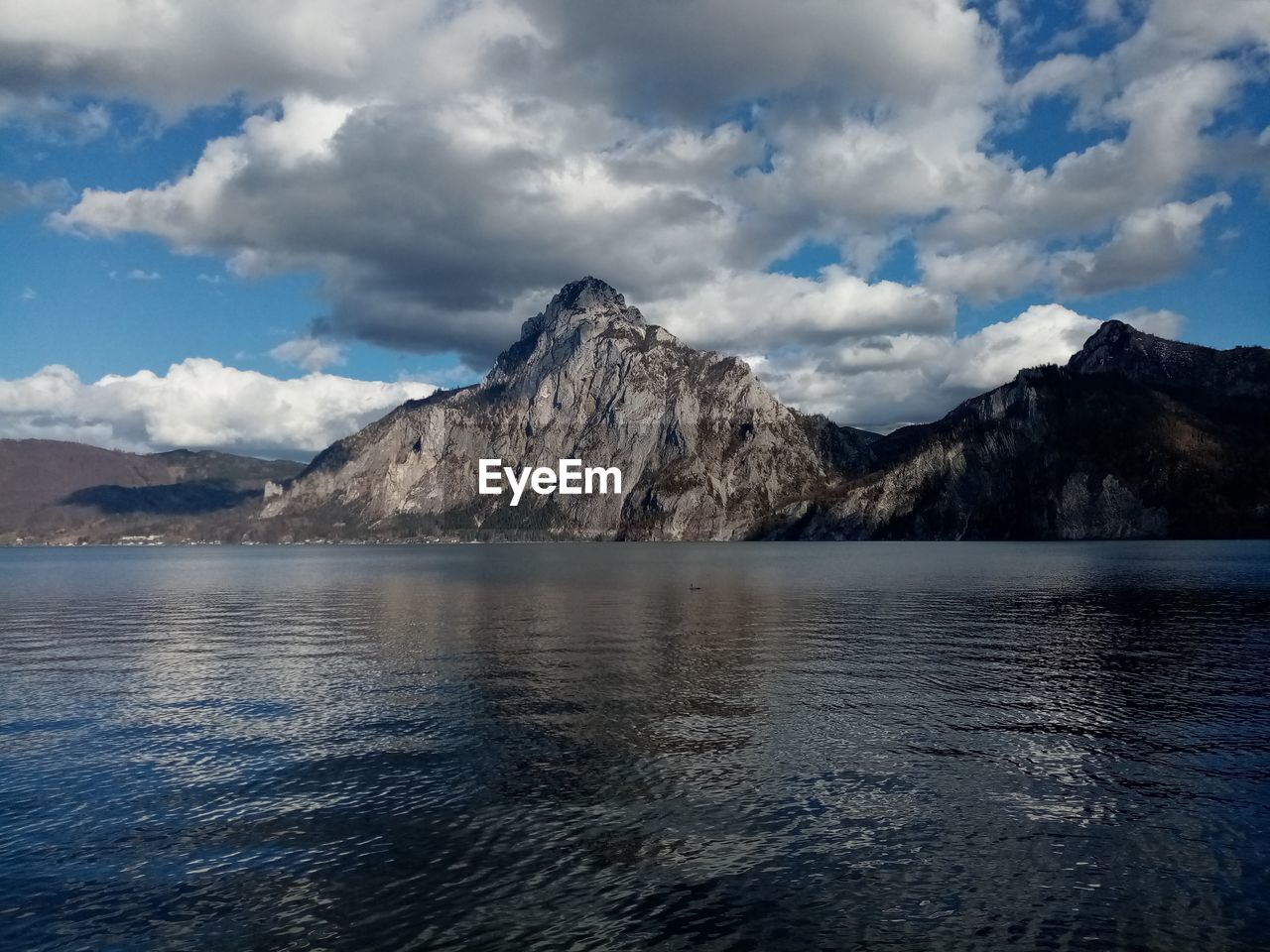 Scenic view of sea and mountains against sky