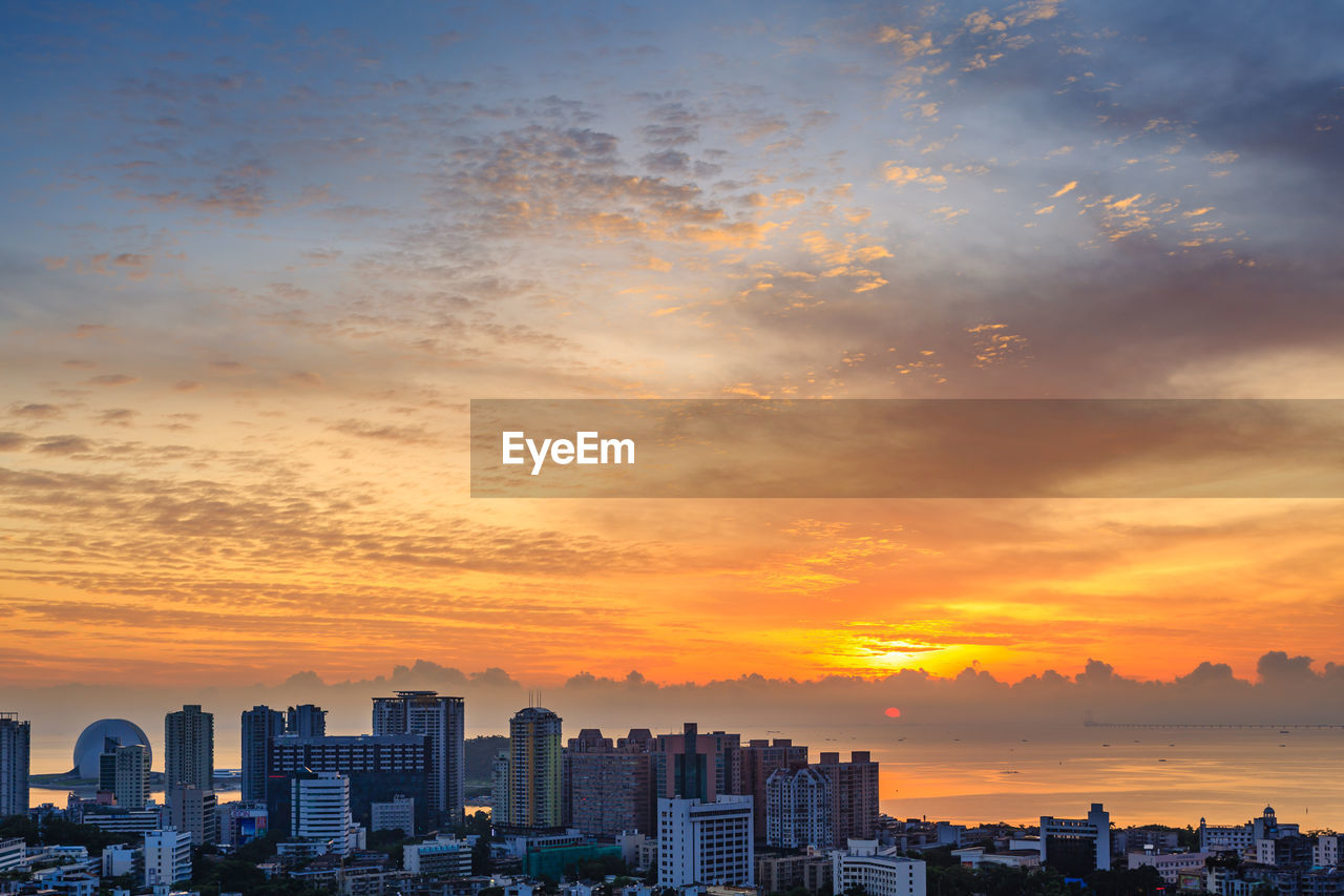 Buildings against sky during sunset