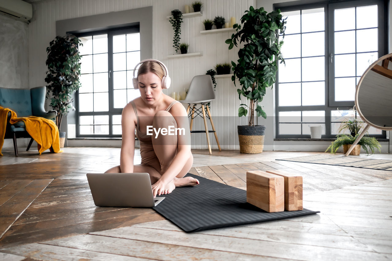 Woman watching work out video at home