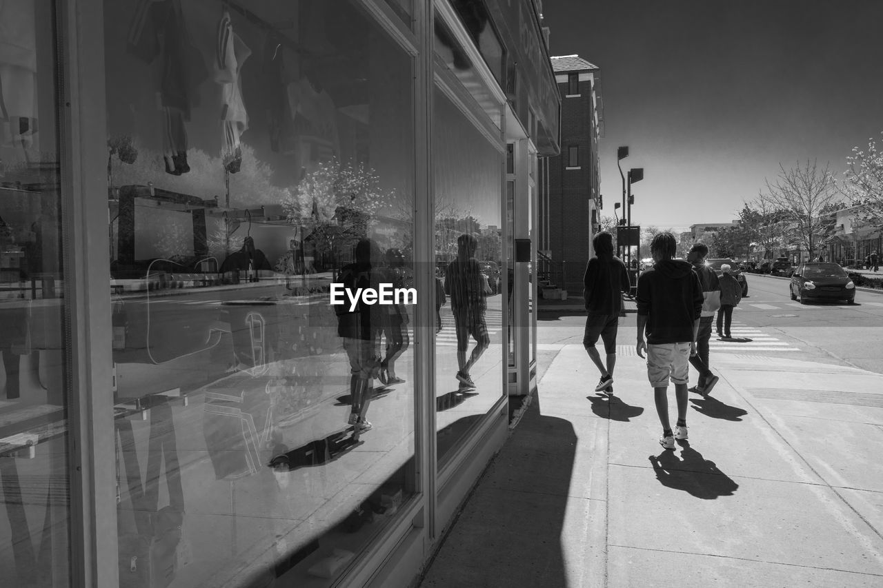 GROUP OF PEOPLE WALKING ON STREET