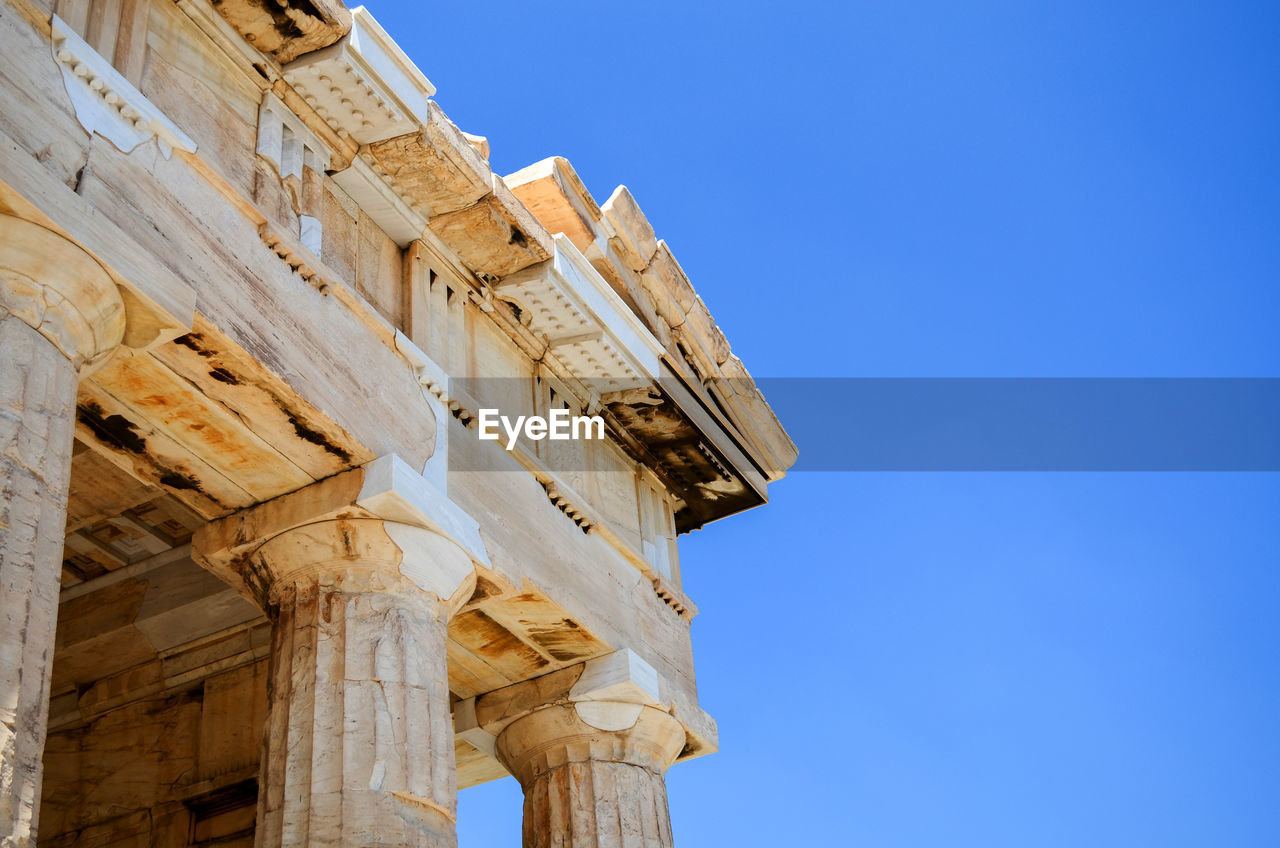 Low angle view of historic building against clear blue sky