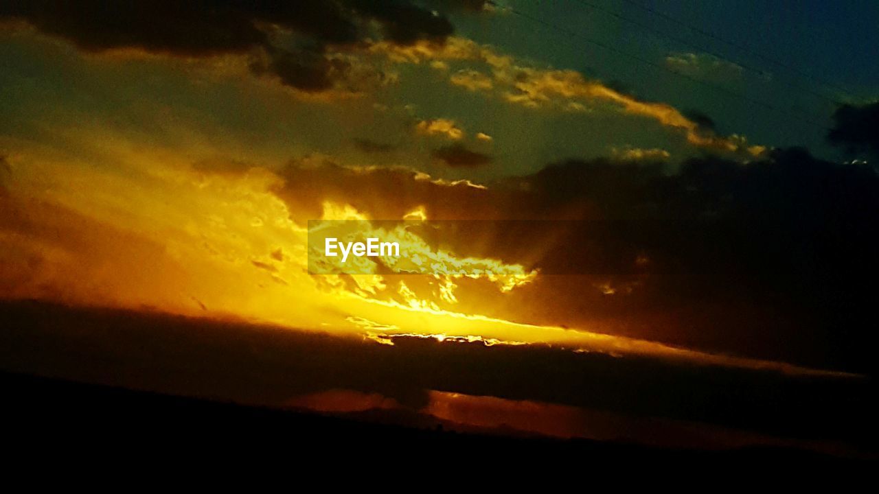 LOW ANGLE VIEW OF DRAMATIC SKY OVER SILHOUETTE LANDSCAPE