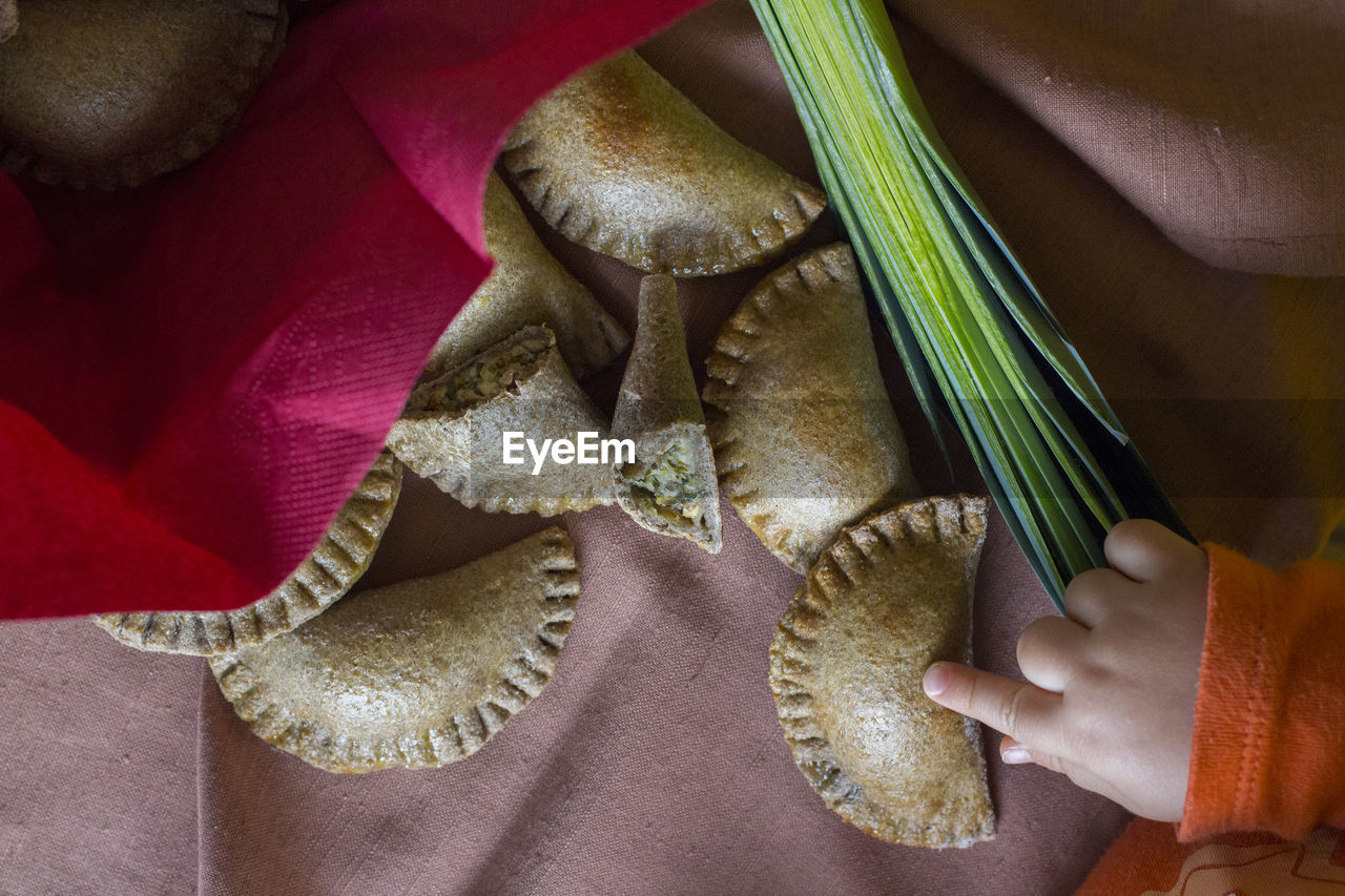 Close-up high angle view of hand touching food