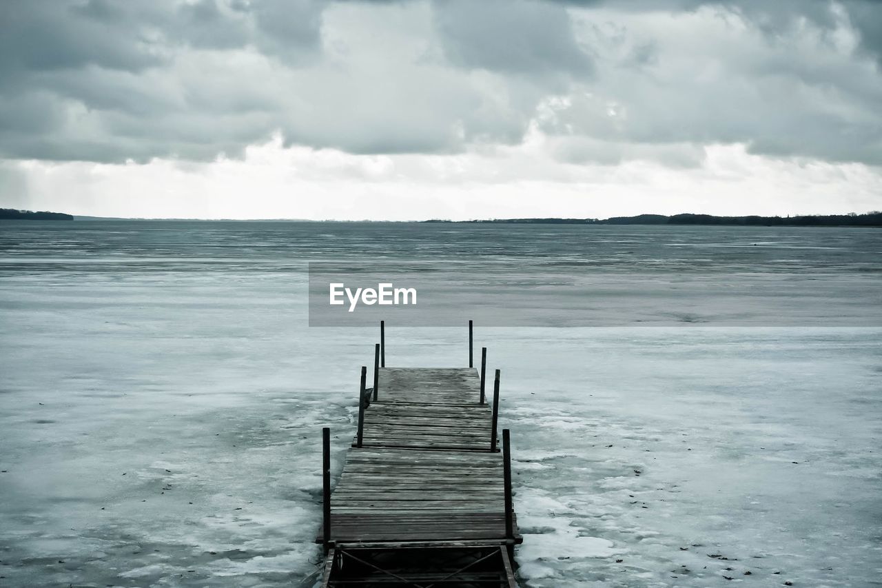 Wooden jetty on frozen sea