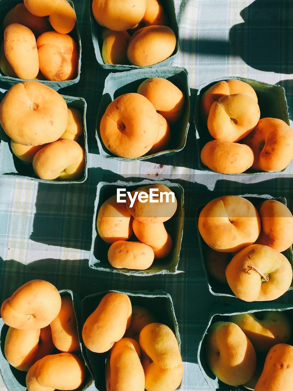 Directly above shot of peaches in box on table for sale in market