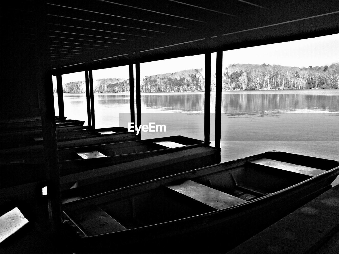 Rowboats under awning on lake