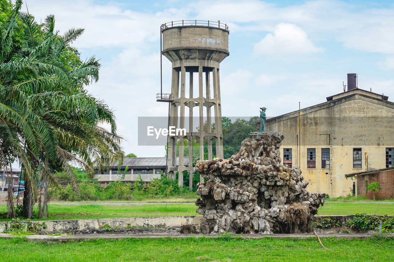 architecture, built structure, plant, building exterior, sky, tree, nature, cloud, grass, building, landmark, no people, day, tower, outdoors, rural area, industry, history, ruins, the past, travel destinations, estate, garden, house