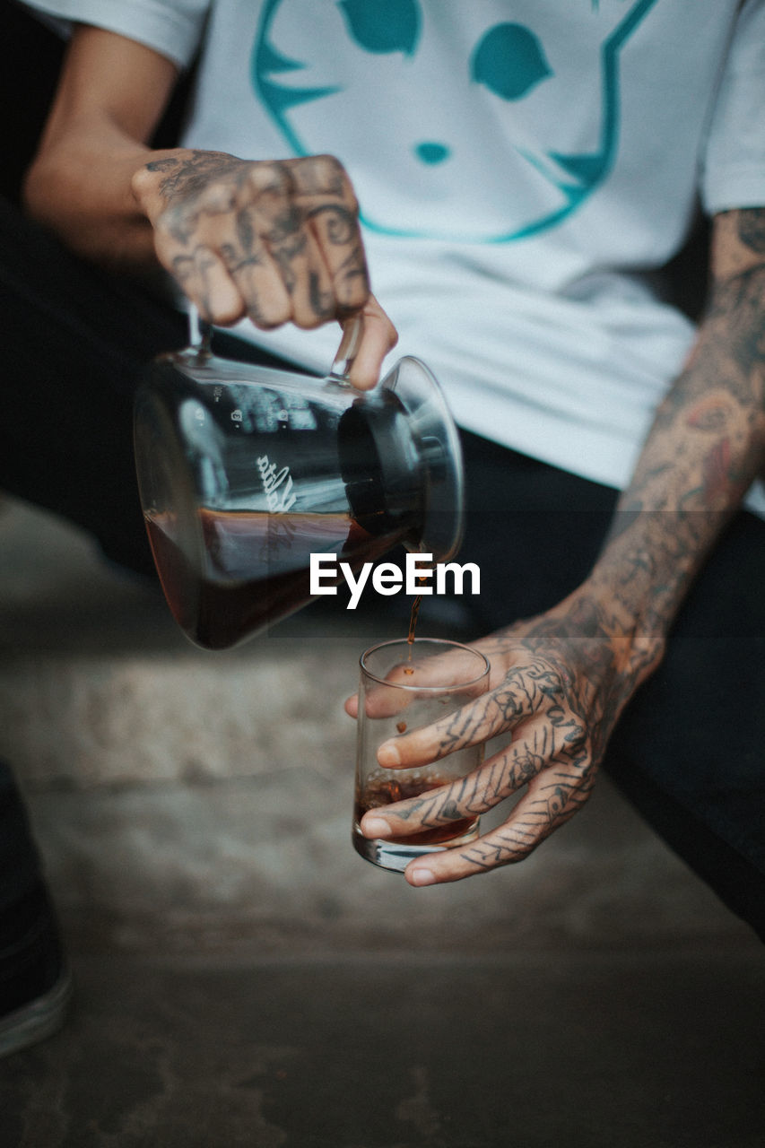 Close-up of man pour coffee