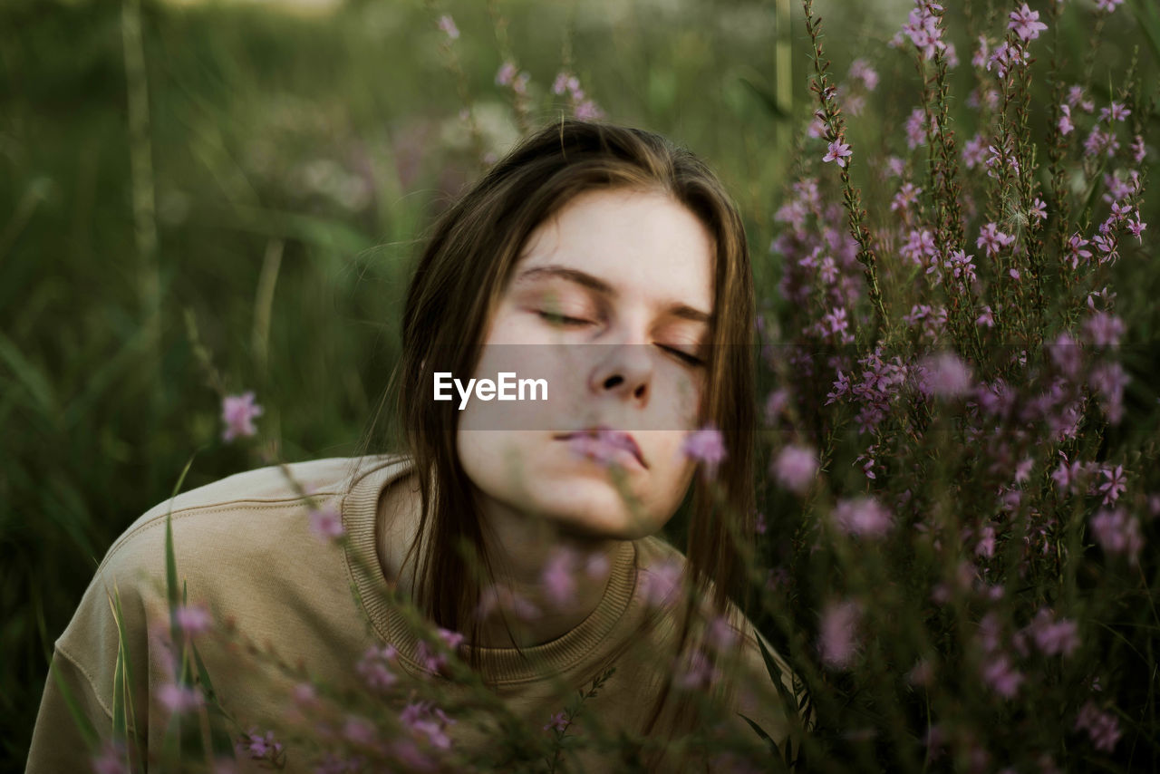 Portrait of a girl with spring wild flowers