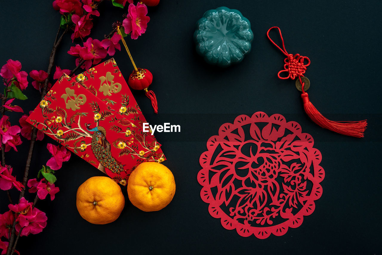 Chinese lunar new year decoration over black background. flat lay concept festive decoration. 