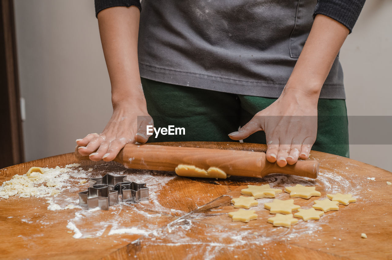 Rolling dough for sweet biscuits in the kitchen