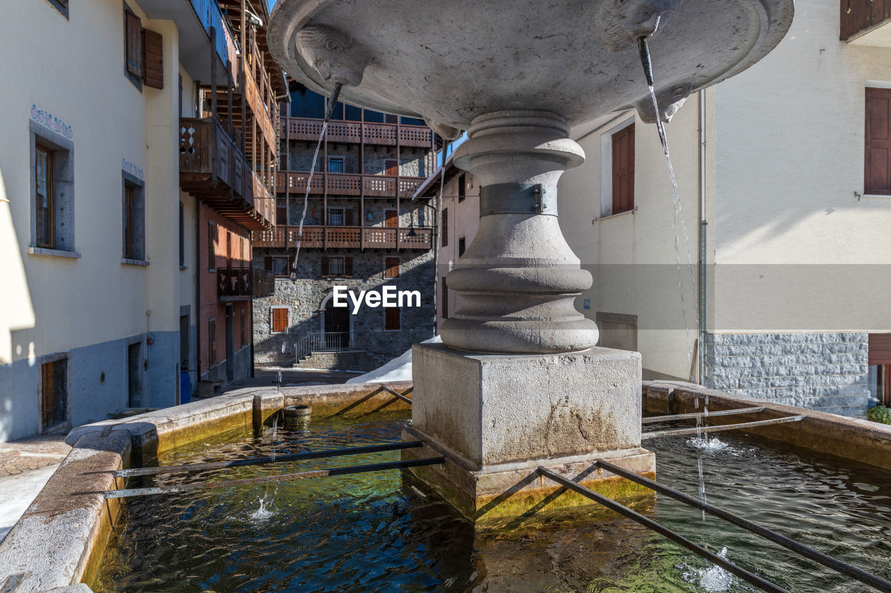 FOUNTAIN AMIDST BUILDINGS