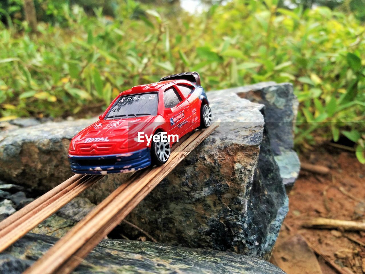 TOY CAR ON ROCK