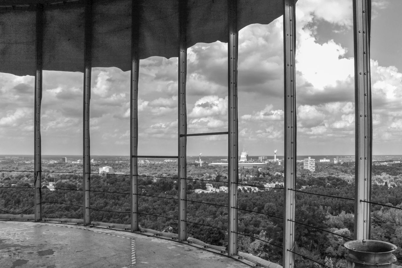 BUILDING SEEN THROUGH GLASS WINDOW