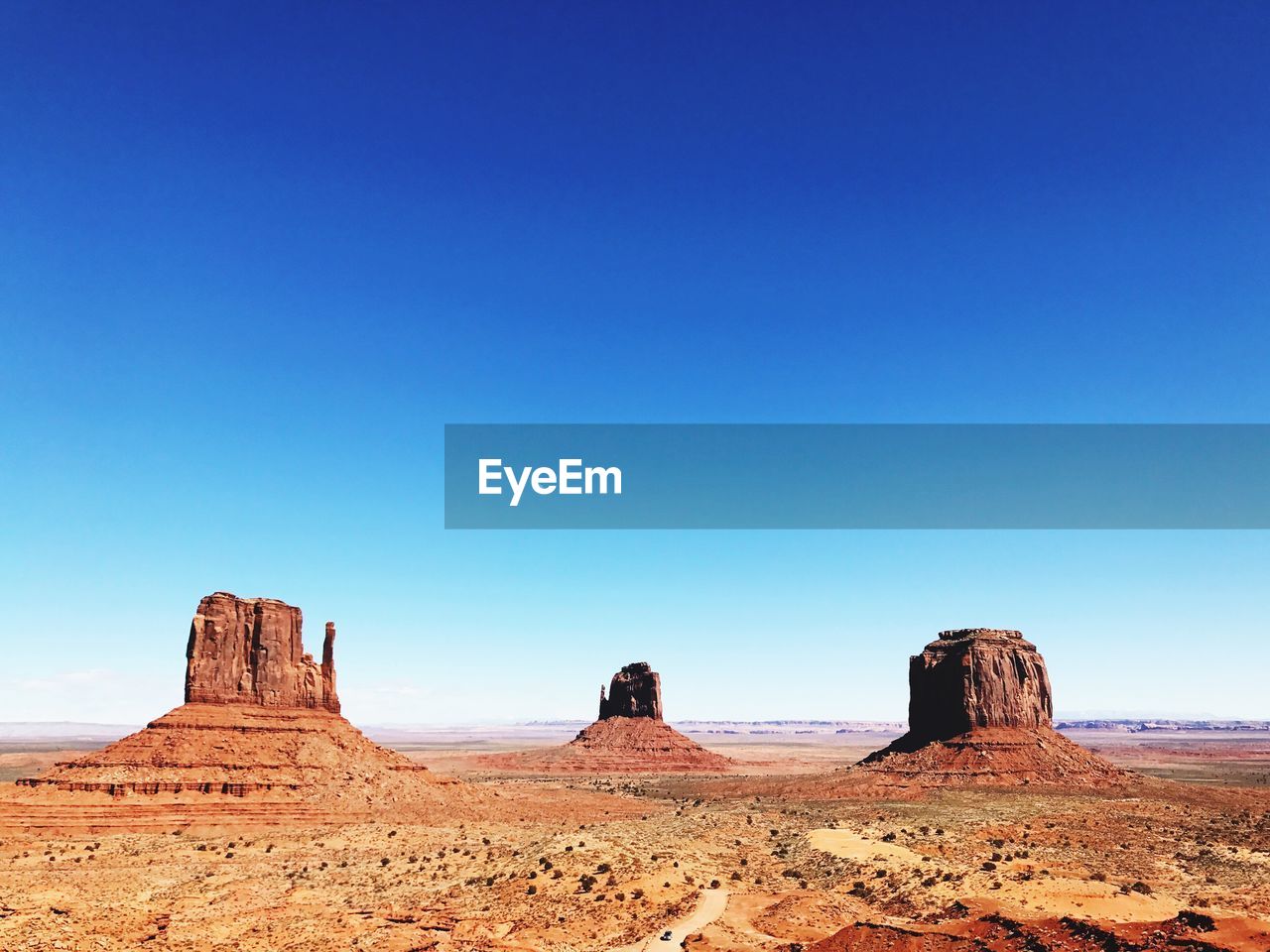 Rock formations in desert against blue sky