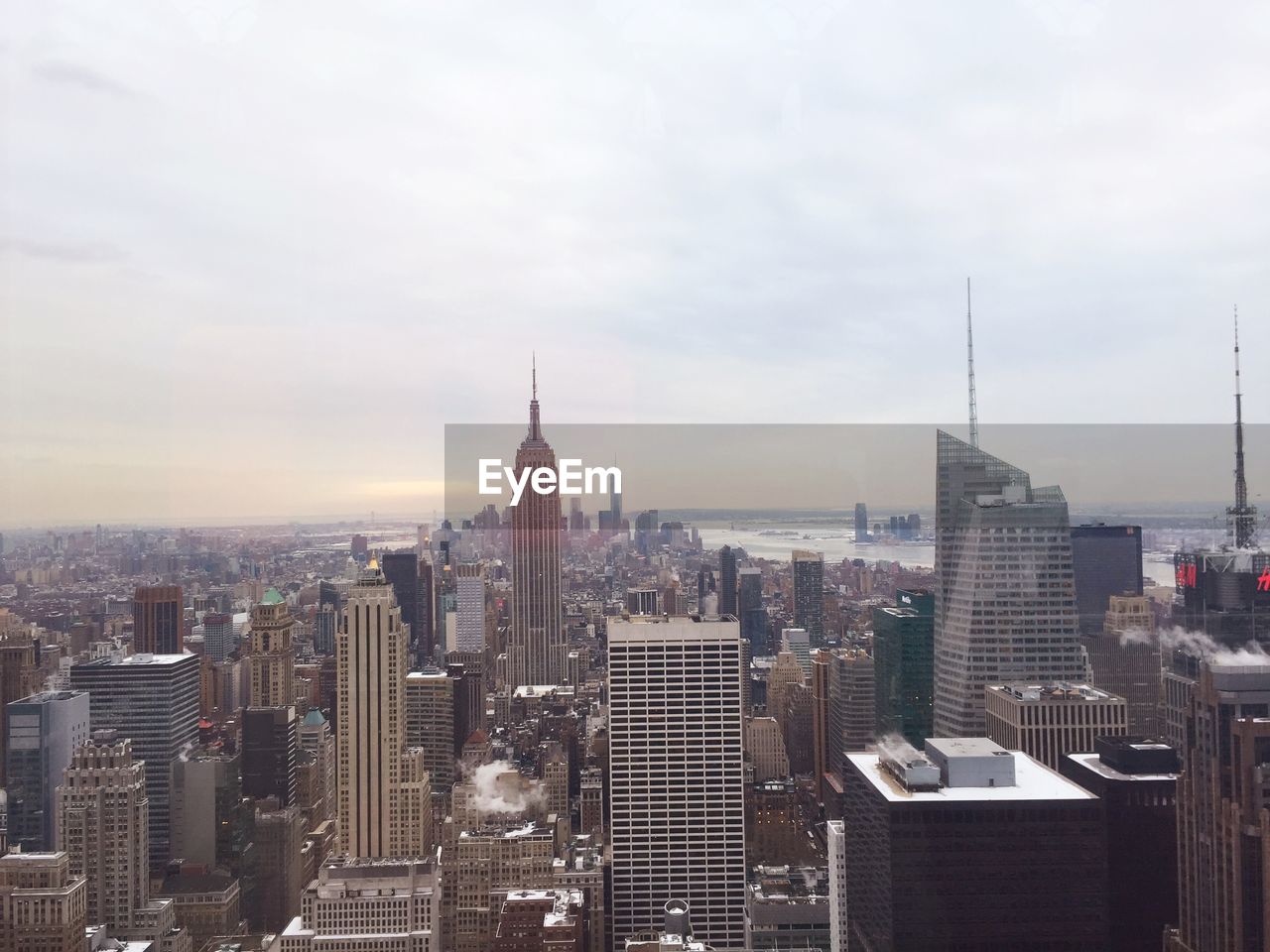 High angle view of cityscape against cloudy sky