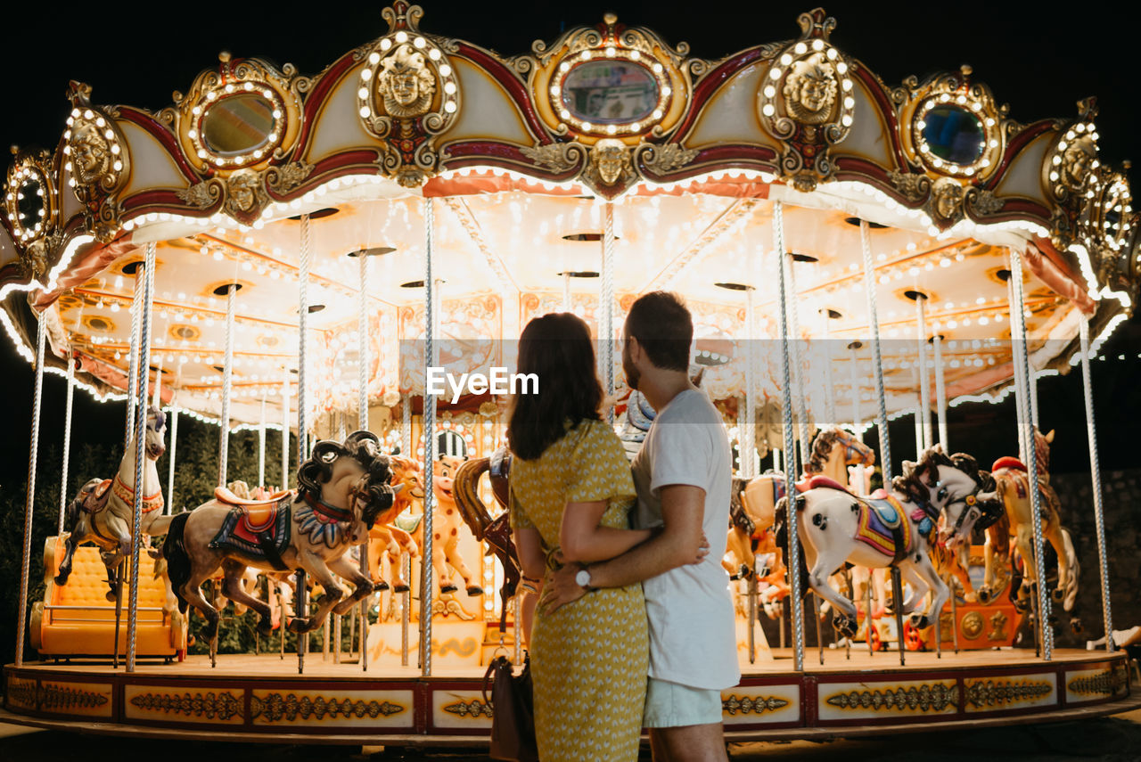 Couple looking at carousel