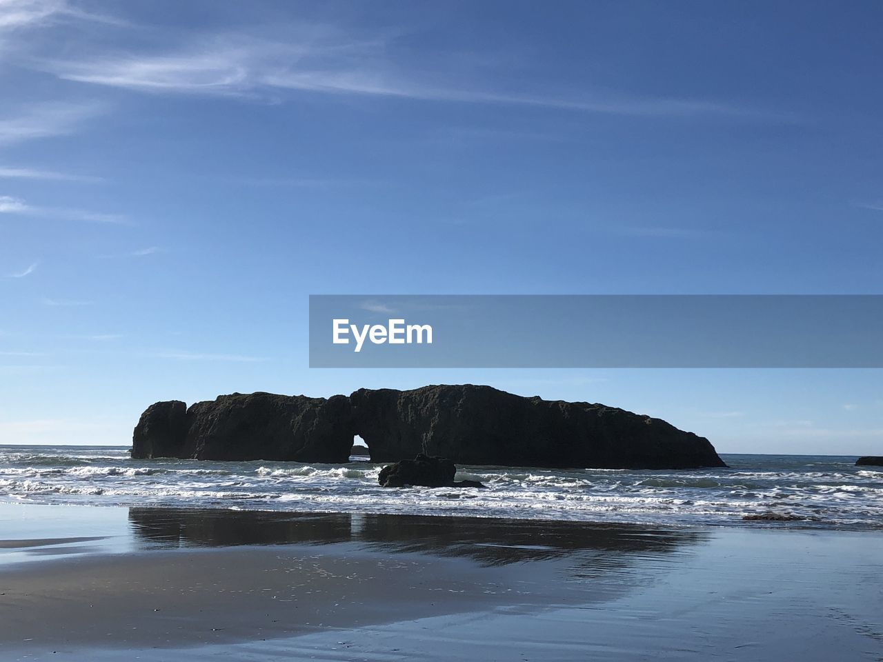 ROCK FORMATIONS ON BEACH AGAINST SKY