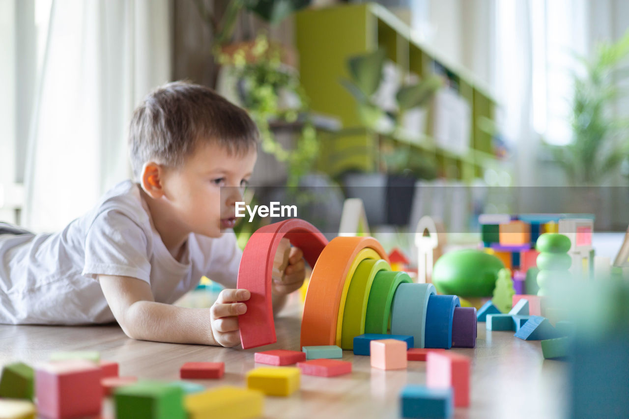 close-up of boy playing with toy blocks on table