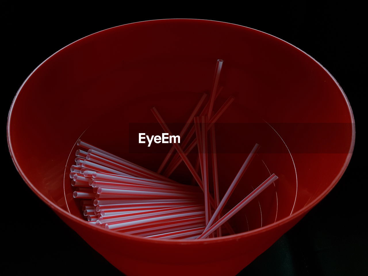 High angle view of straws in red container