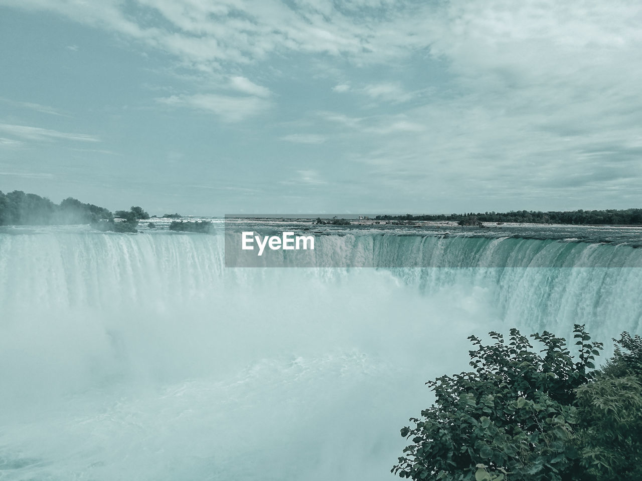PANORAMIC SHOT OF WATERFALL AGAINST SKY