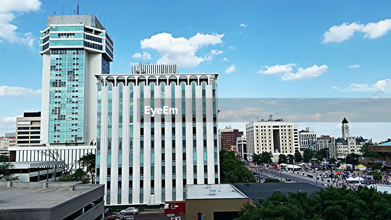 VIEW OF BUILDINGS AGAINST CLOUDY SKY