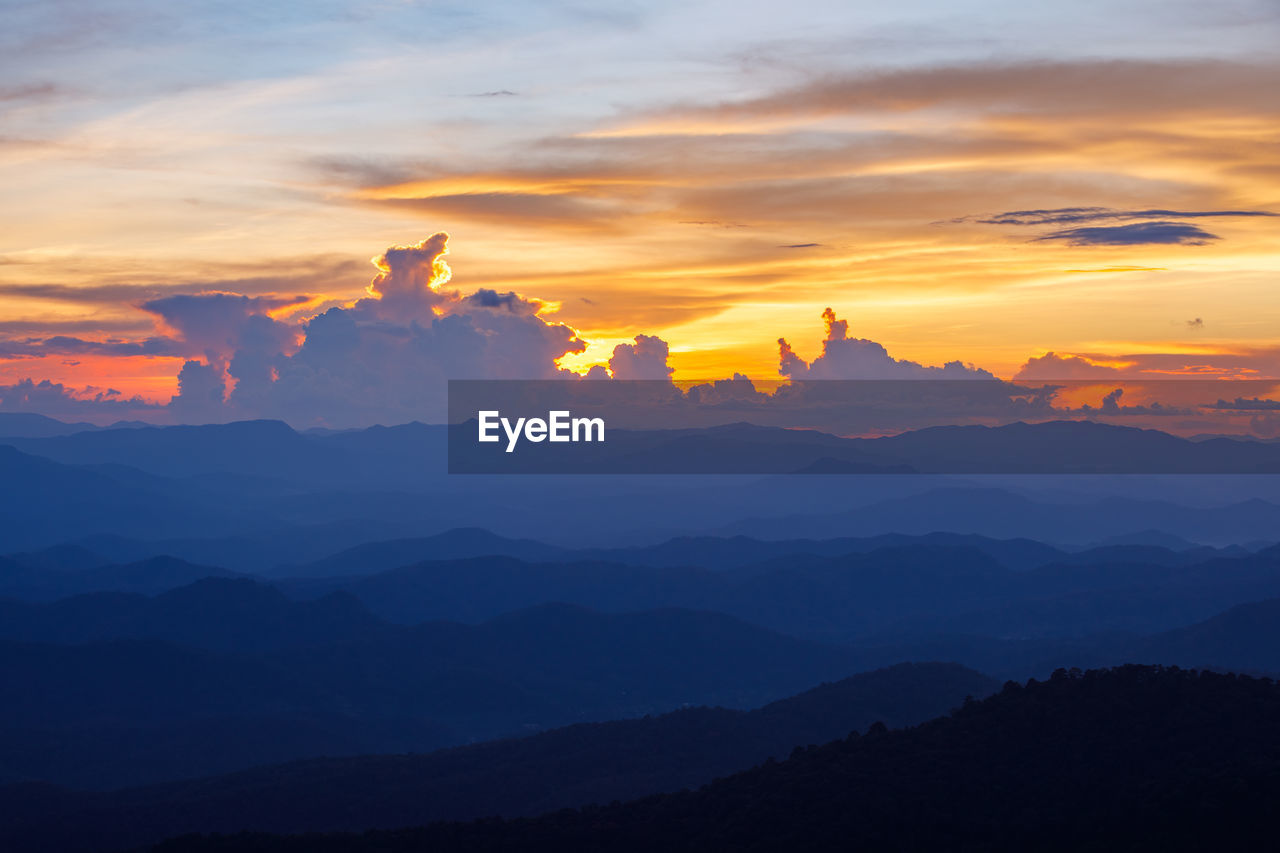 SCENIC VIEW OF MOUNTAINS AGAINST DRAMATIC SKY