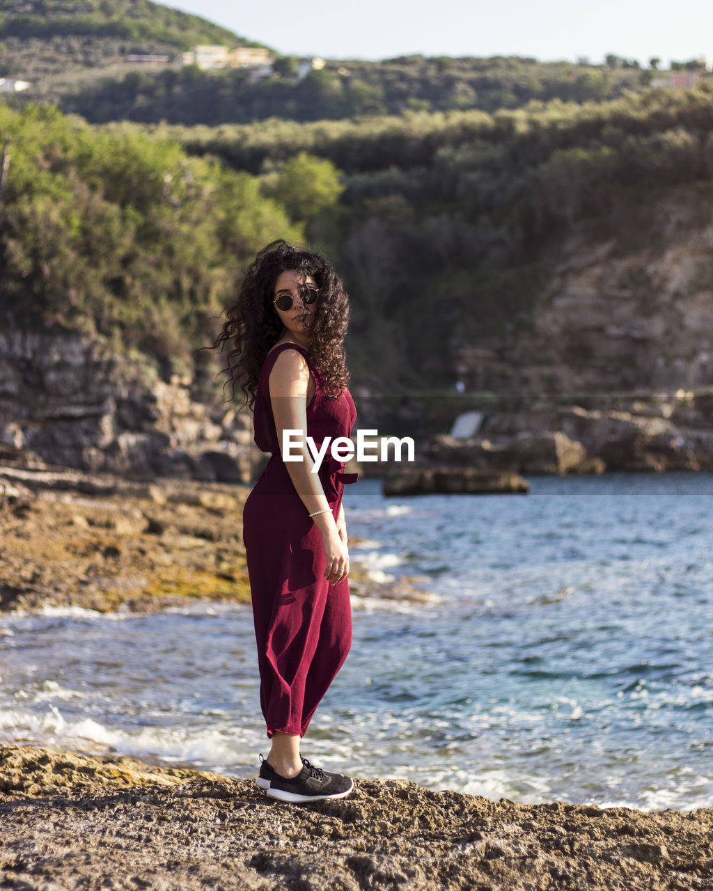 Full length portrait of woman standing at beach