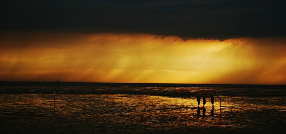 Scenic view of beach and sea against sky during sunset