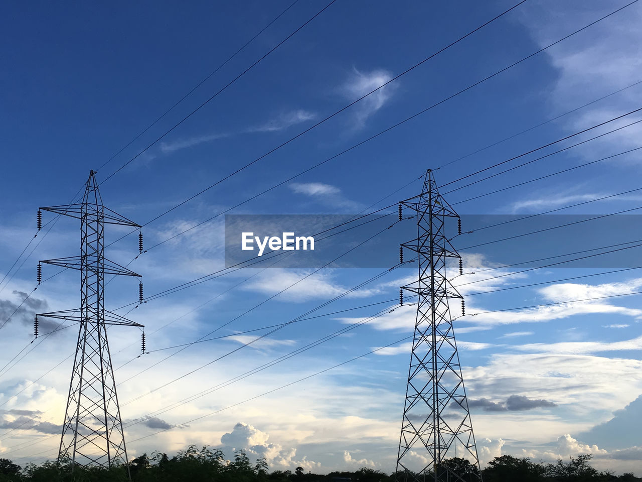Low angle view of electricity pylon against the sky