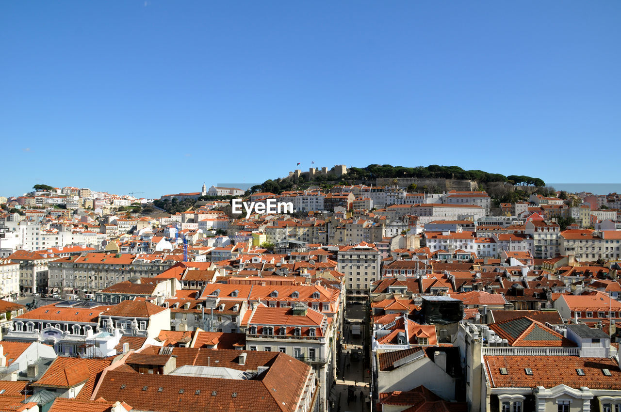 High angle view of cityscape against clear blue sky