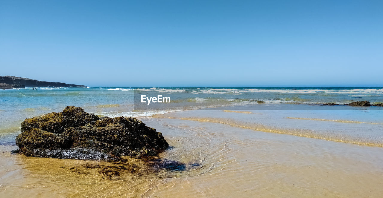 Scenic view of sea against clear sky