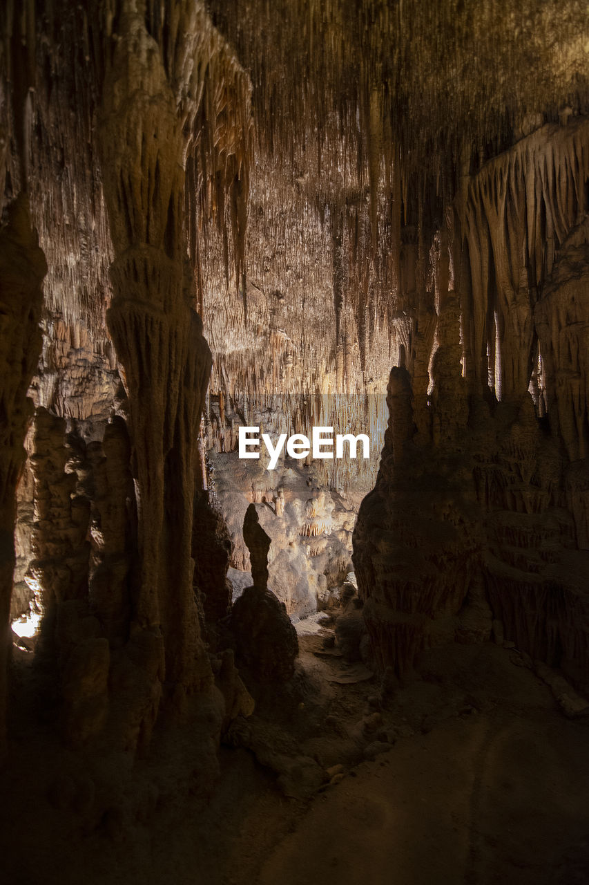 ROCK FORMATIONS IN CAVE AT DUSK