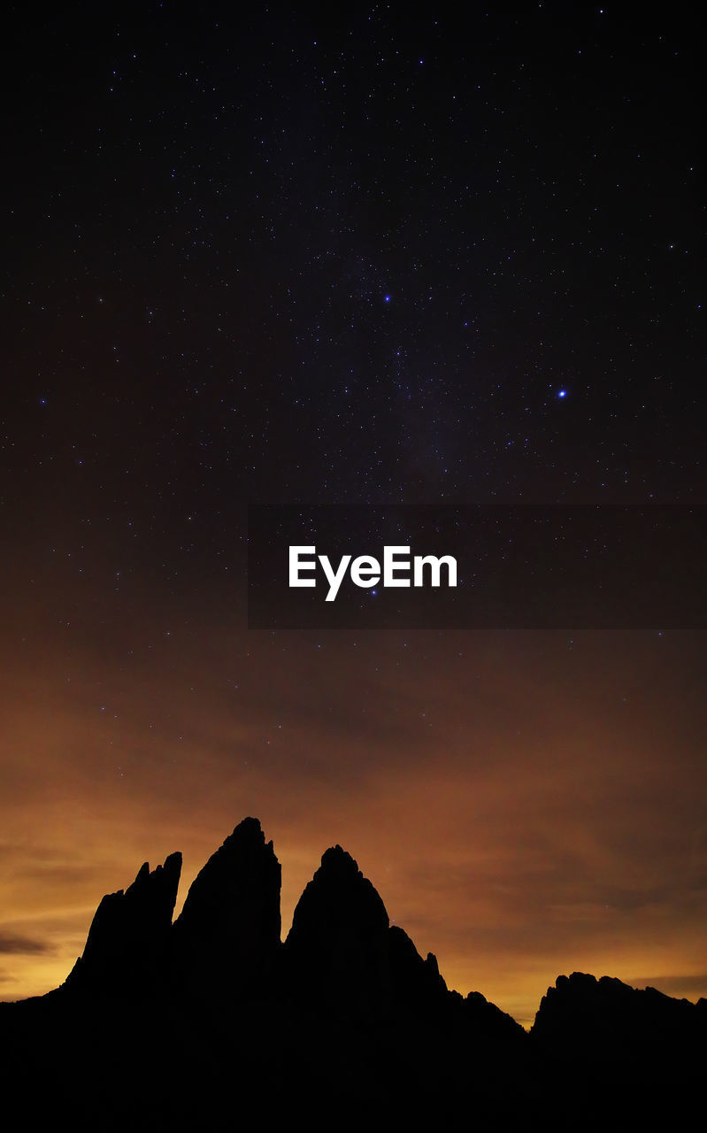 LOW ANGLE VIEW OF SILHOUETTE MOUNTAIN AGAINST SKY AT SUNSET