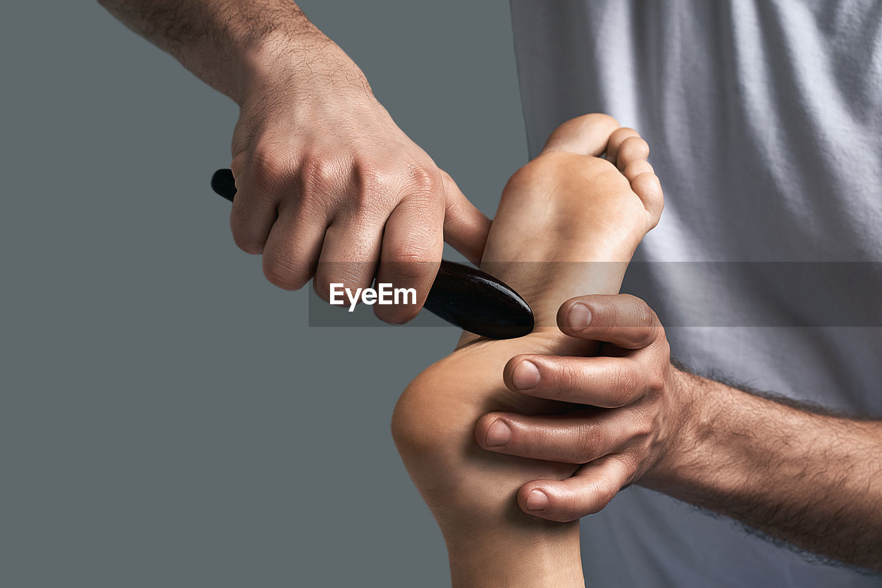 hand, arm, limb, finger, adult, men, indoors, close-up, studio shot, human leg, holding, human limb, one person, person, strength