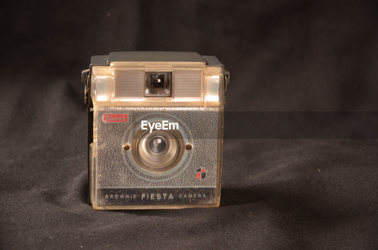 CLOSE-UP OF OLD CAMERA ON TABLE