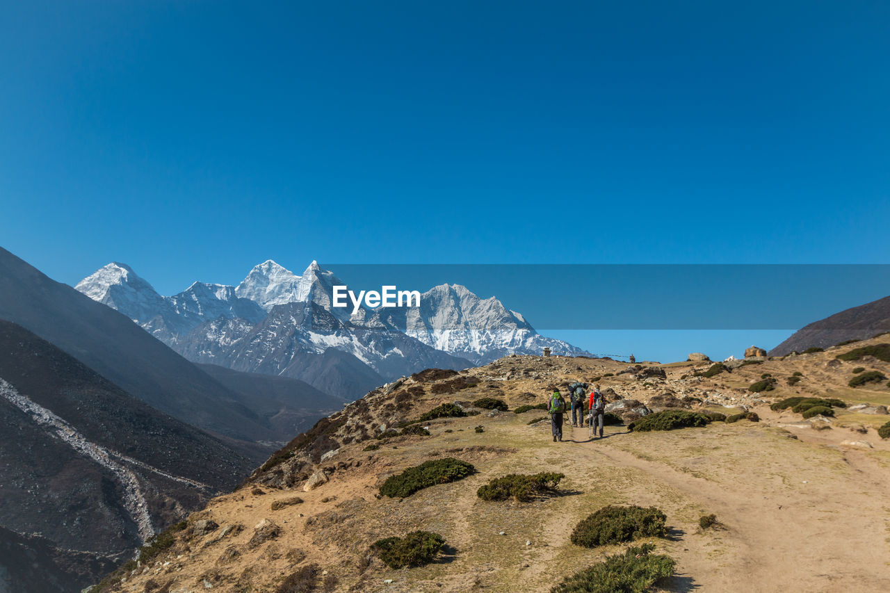 SCENIC VIEW OF MOUNTAINS AGAINST BLUE SKY