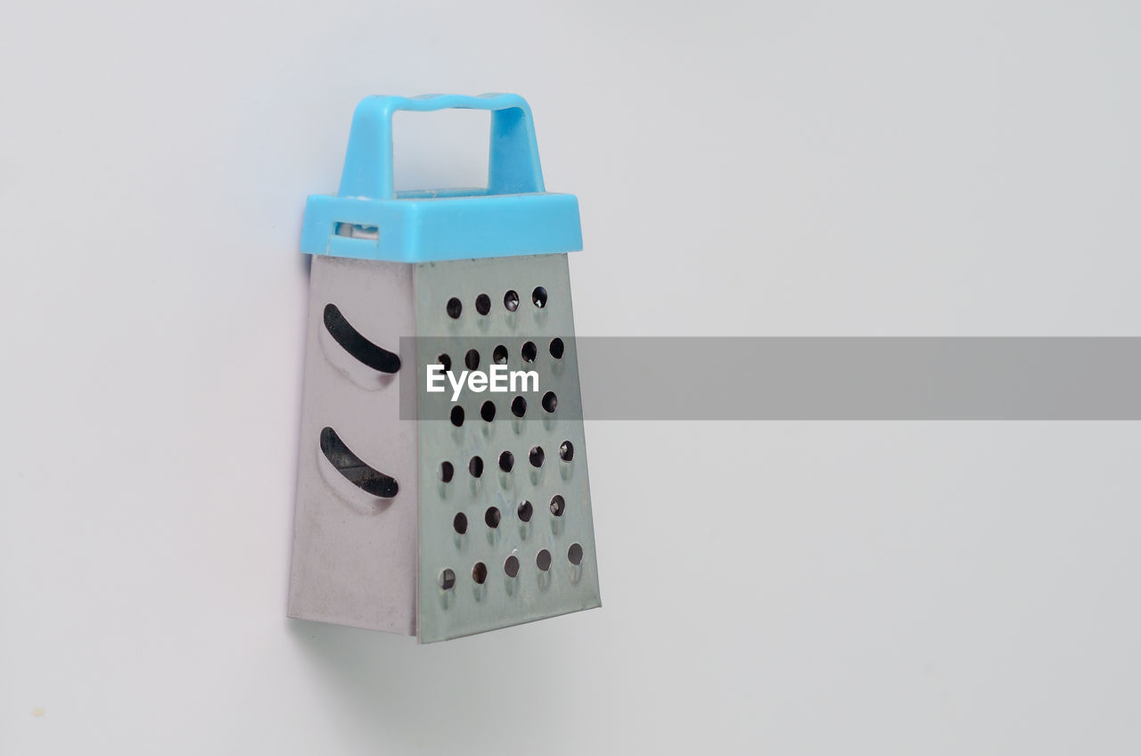 Mini grater for vegetables and fruits on a white background
