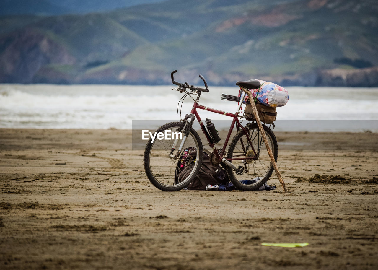 Bicycle on beach against sea