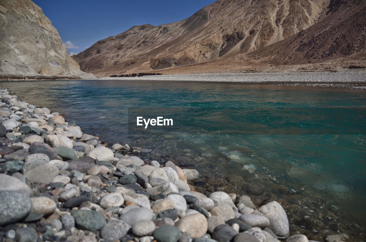 Scenic view of lake and mountains against sky