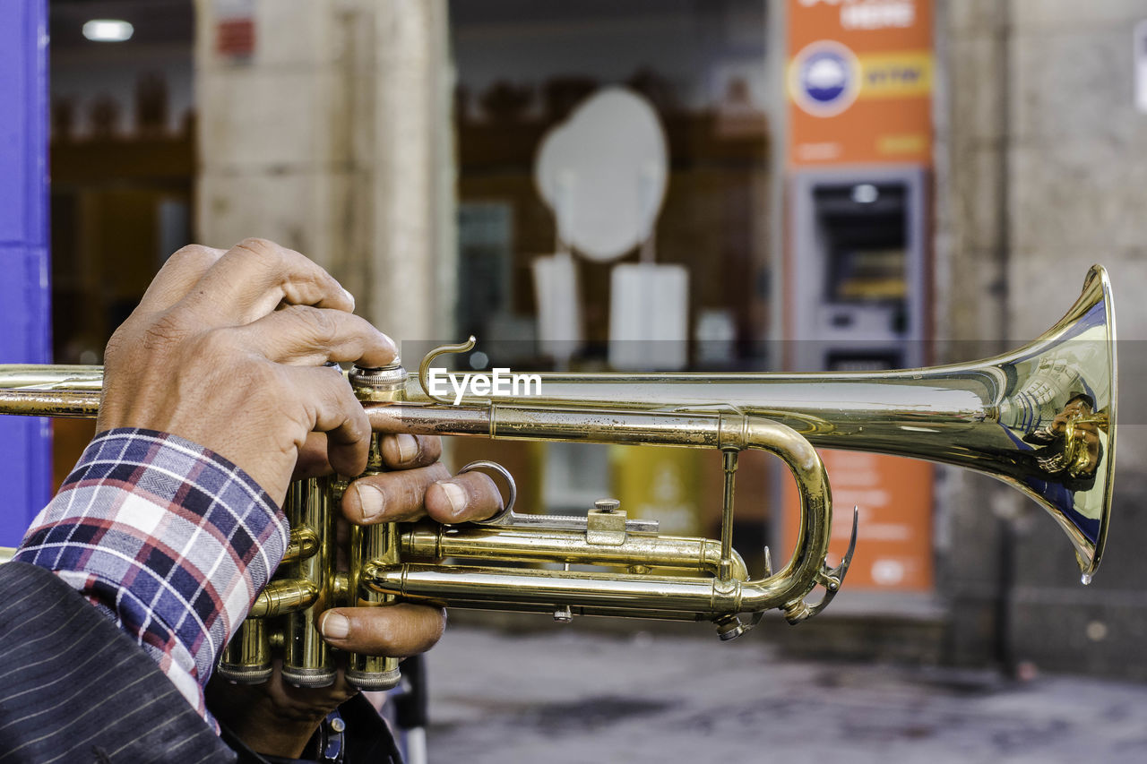 Cropped hands playing trumpet