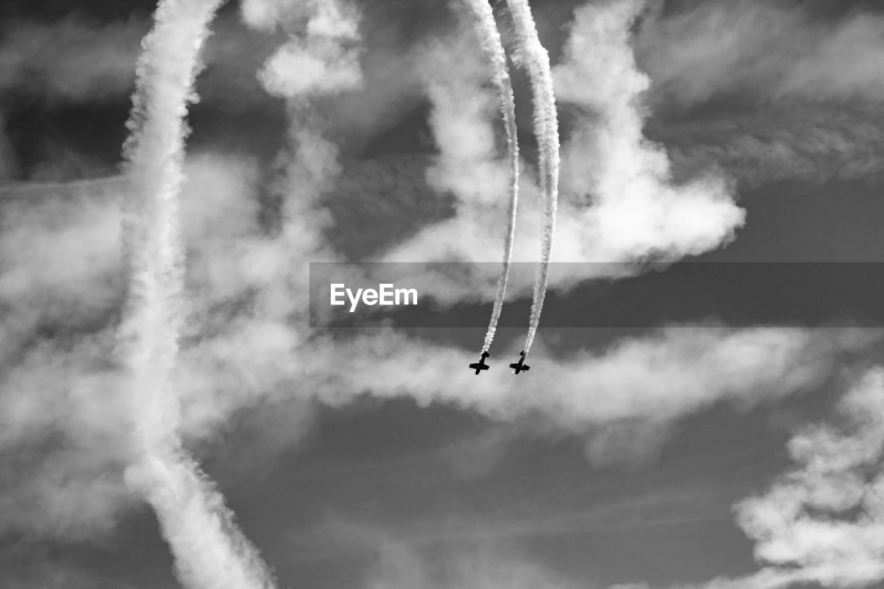 Low angle view of airplane flying against sky