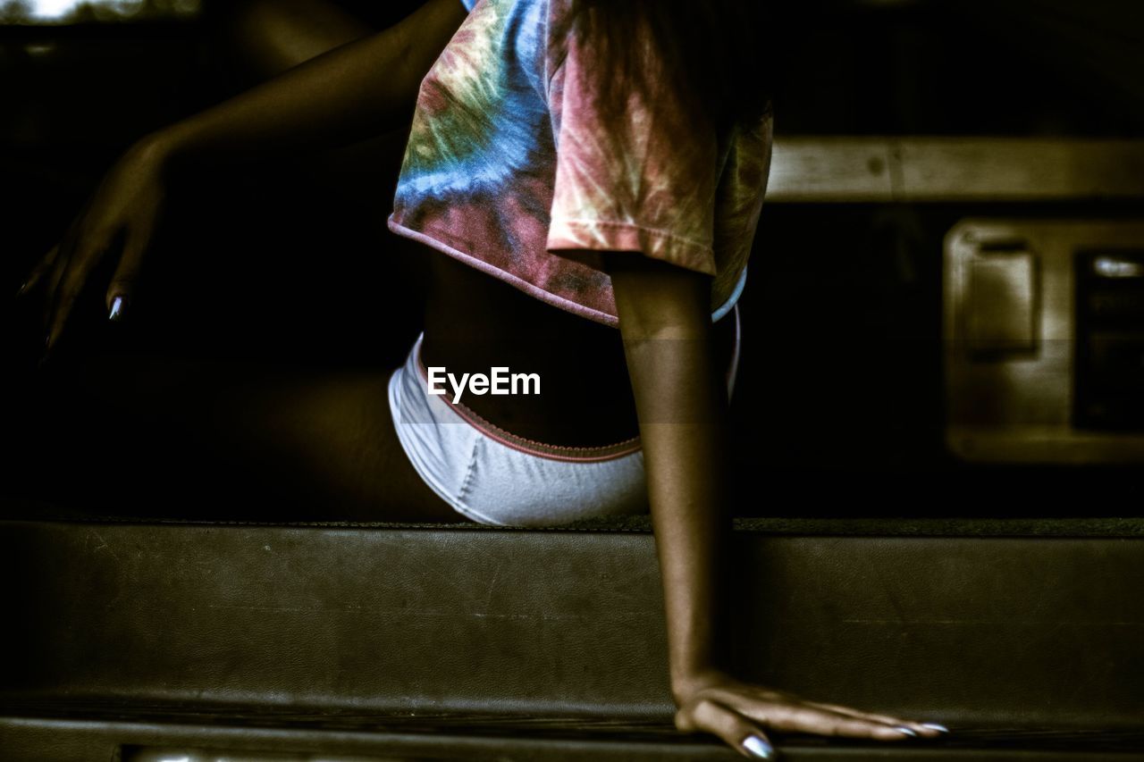 Low section of woman standing on tiled floor