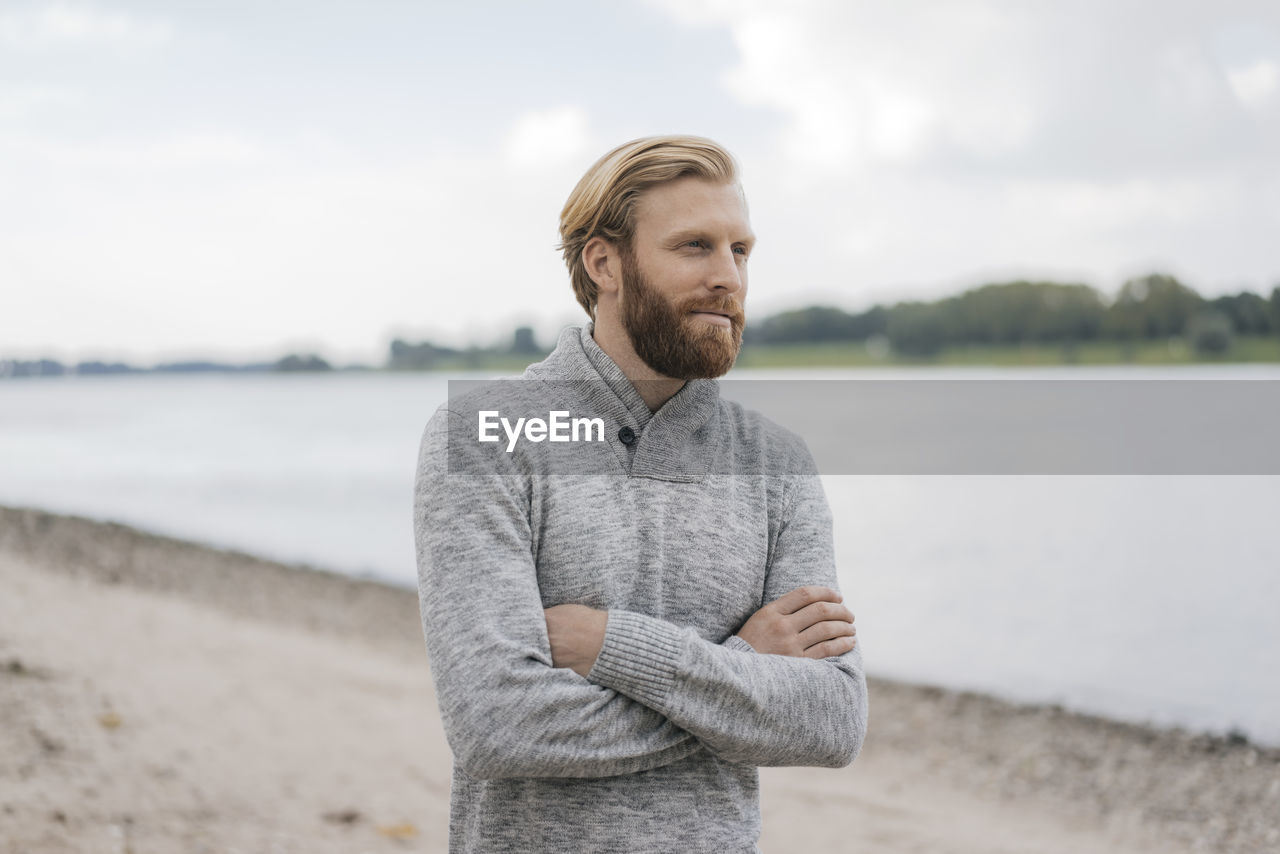 Germany, duesseldorf, portrait of man on the beach