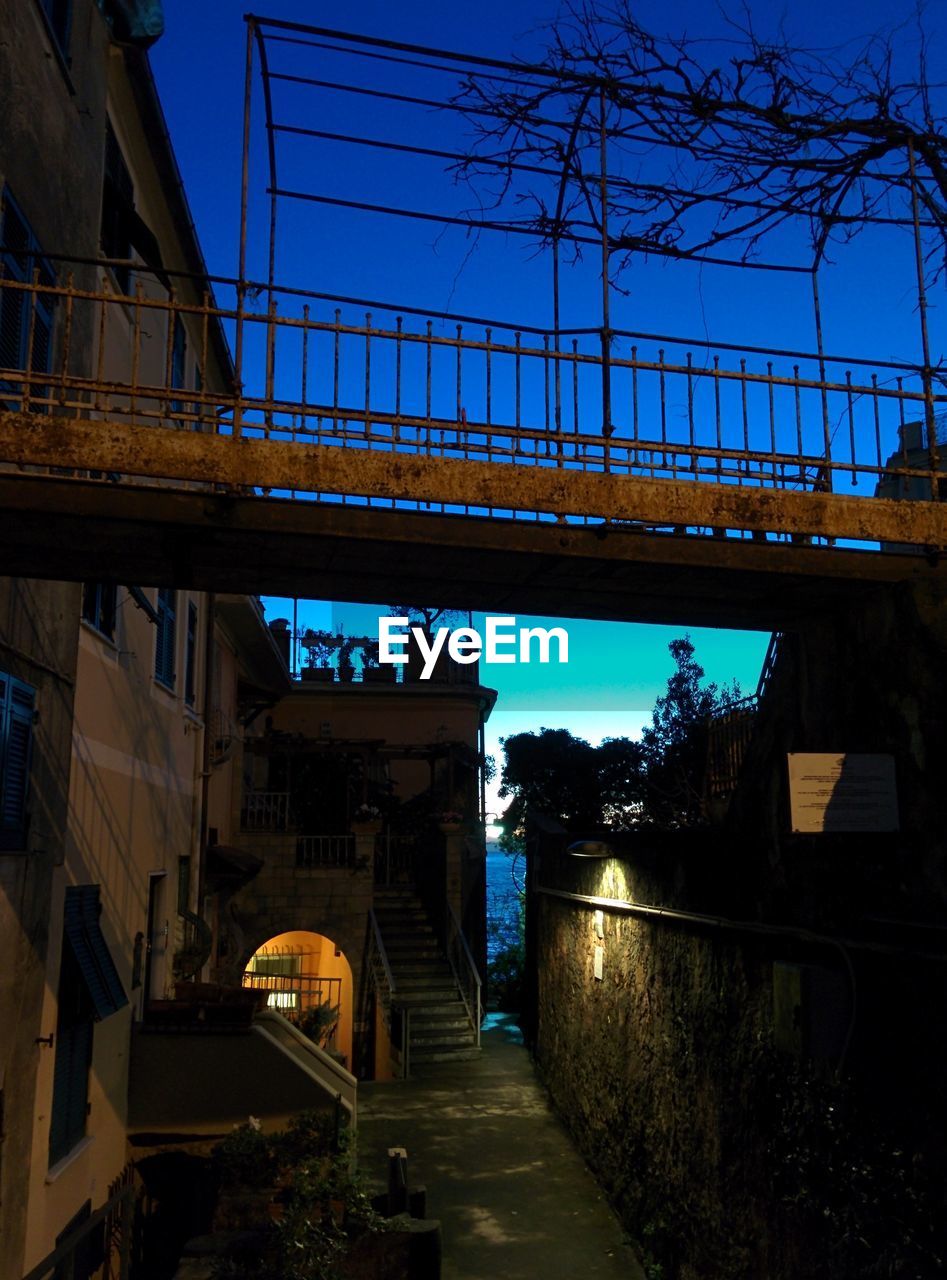 BRIDGE OVER RIVER WITH CITY IN BACKGROUND